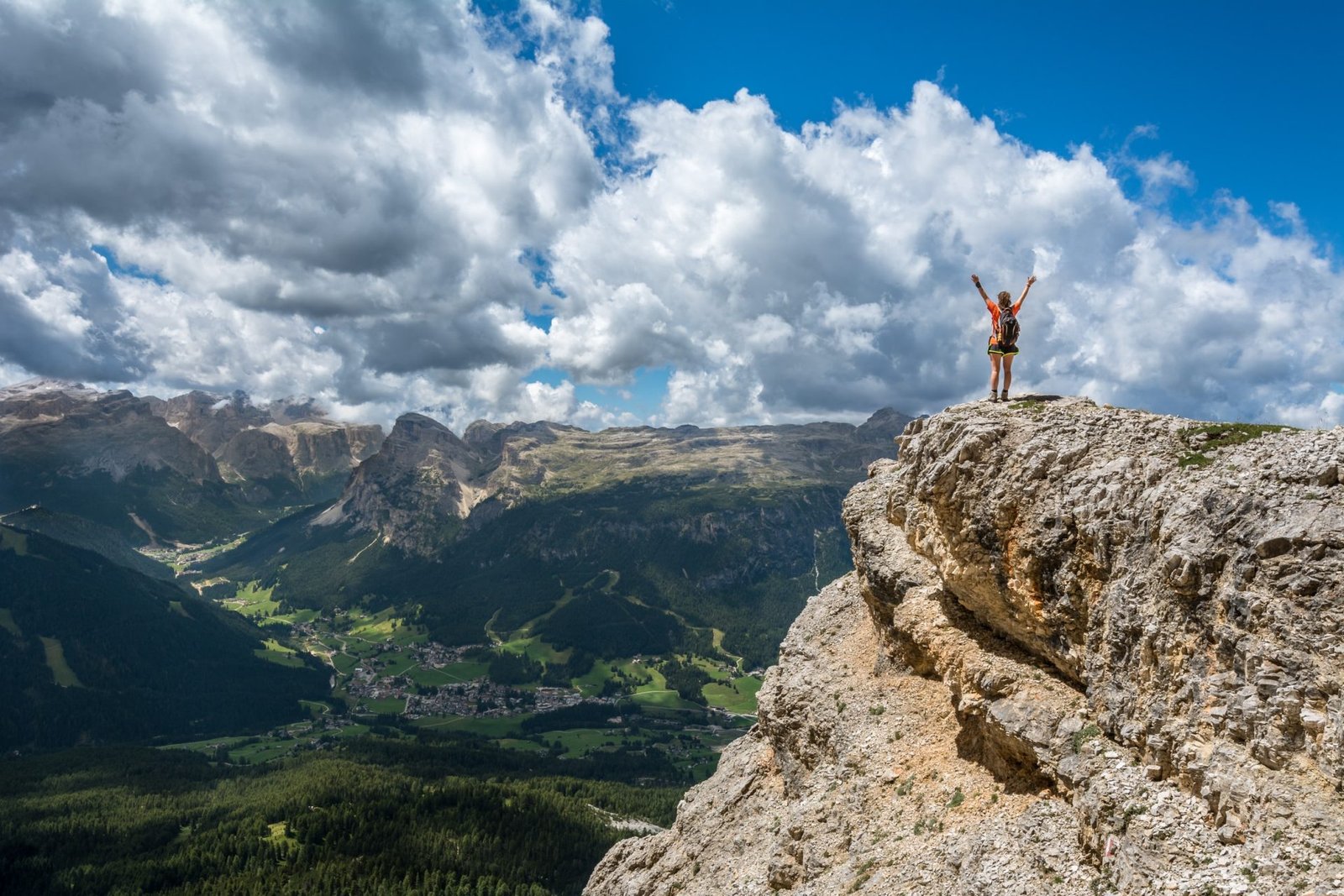 person on to top of the mountain celebrating achievement